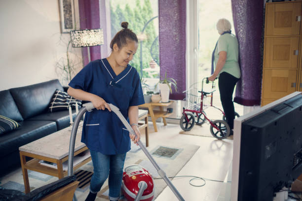 Caring touch homemaker cleaning and organizing a living room